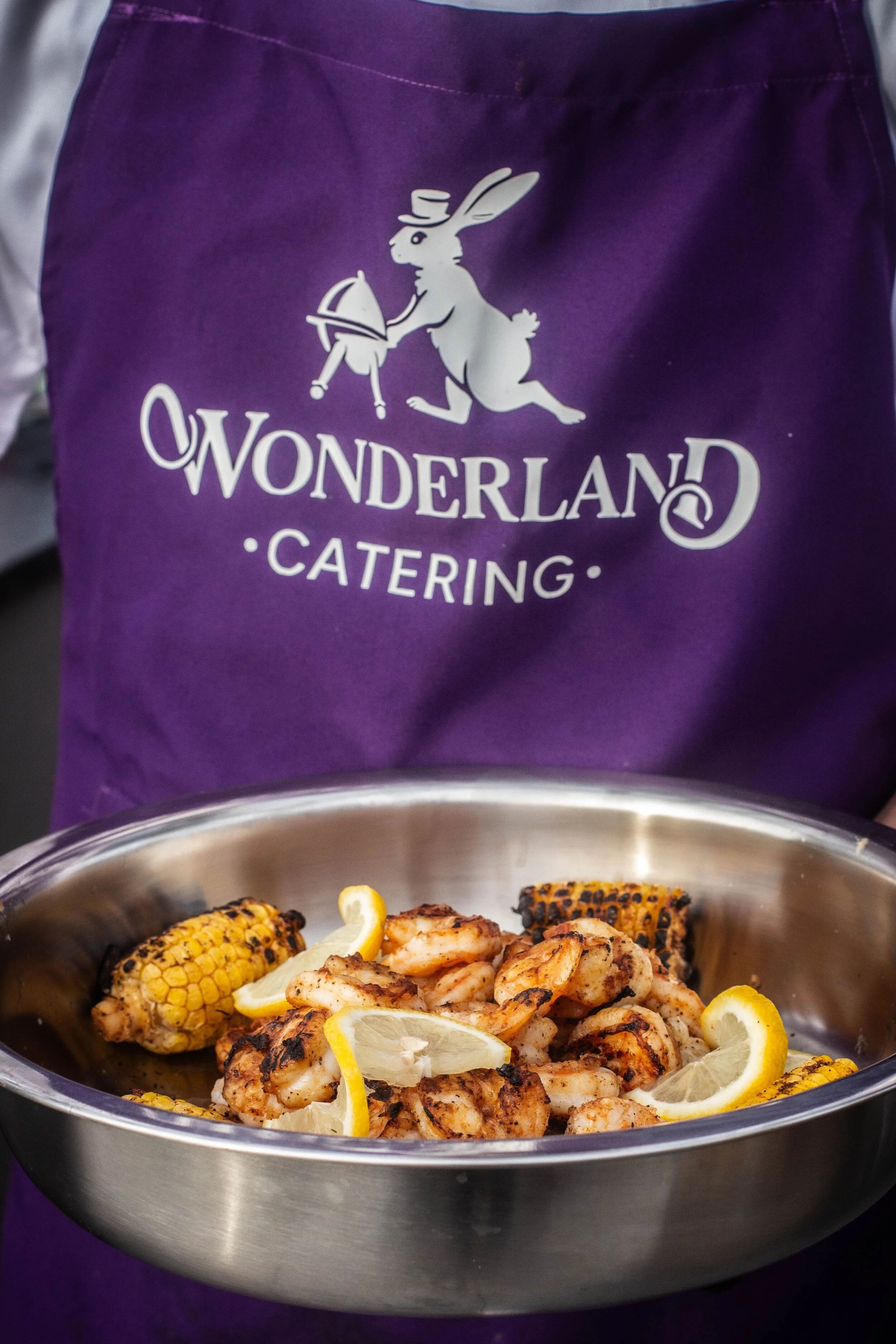 Grilled shrimp and corn served in front of the Wonderland Catering apron