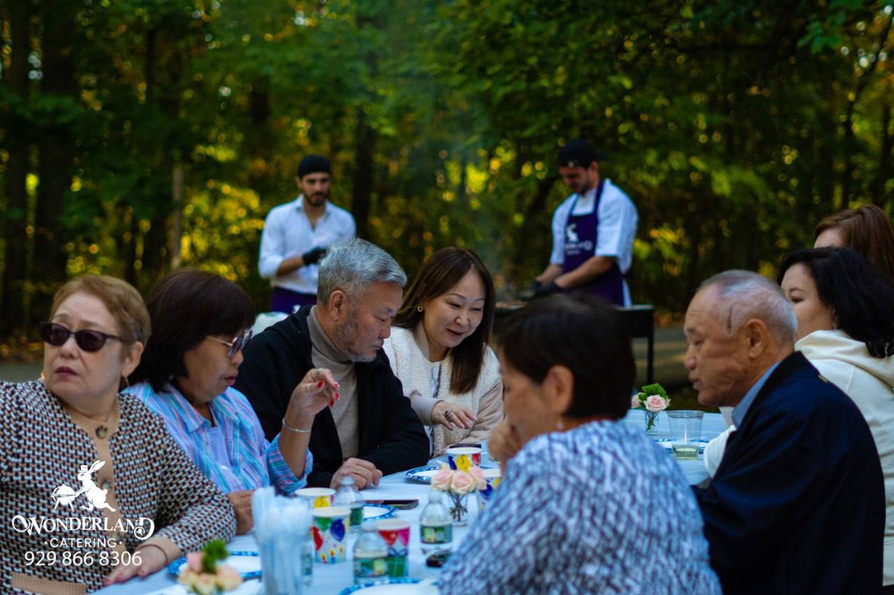 Guests gathered at the family table in the park