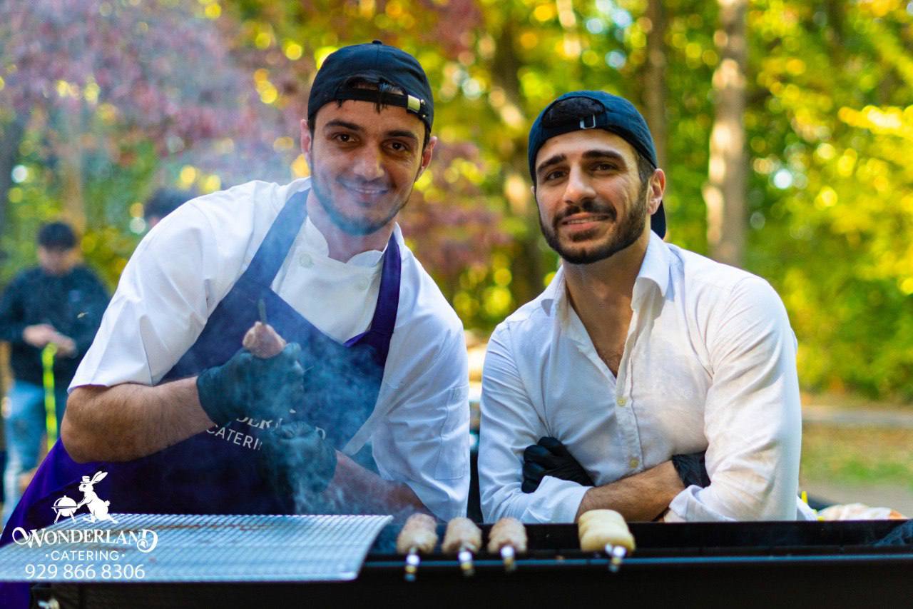 Windsor Catering team beside the grill at a park celebration