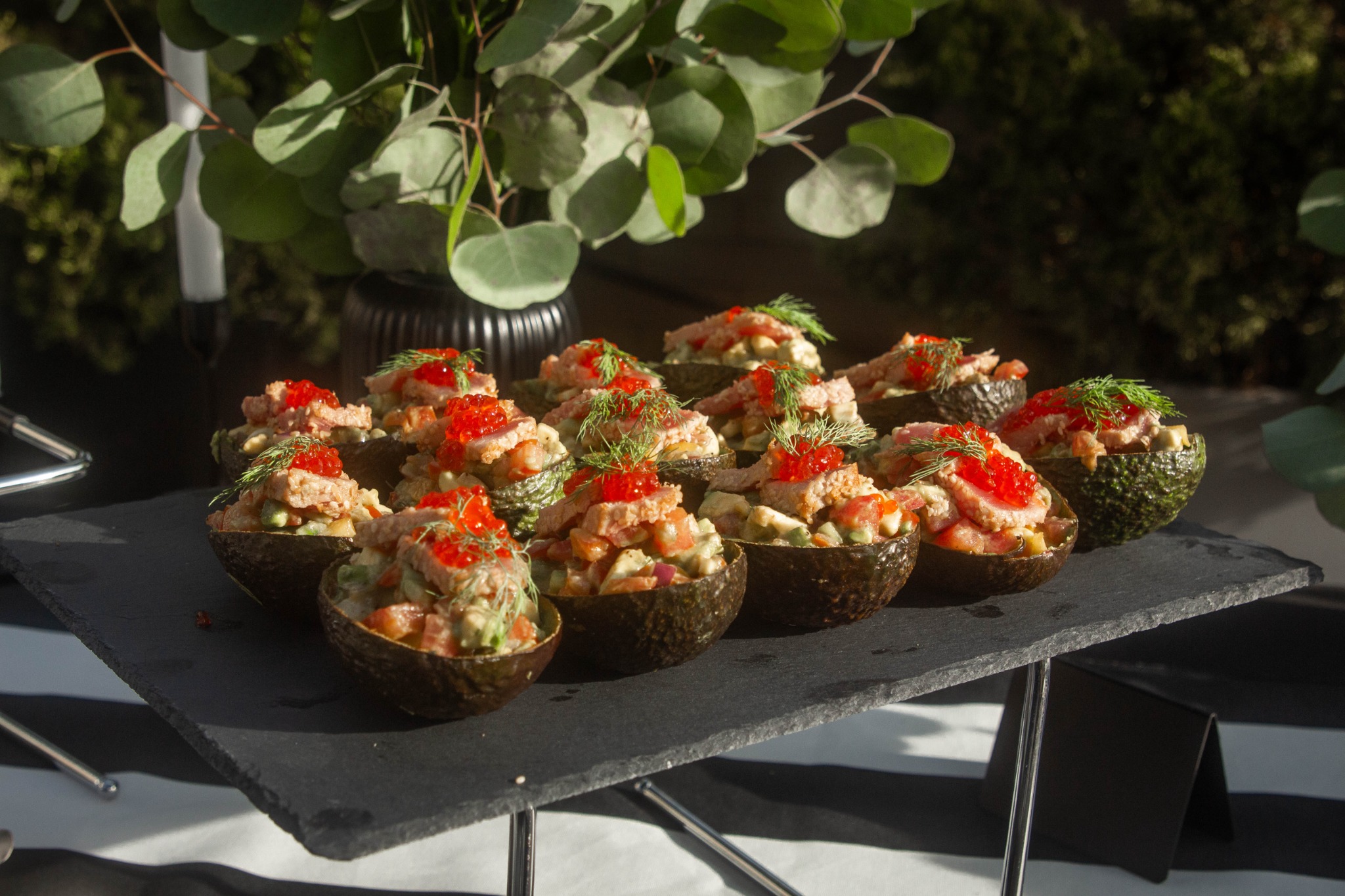 Avocado appetizers topped with seafood and roe